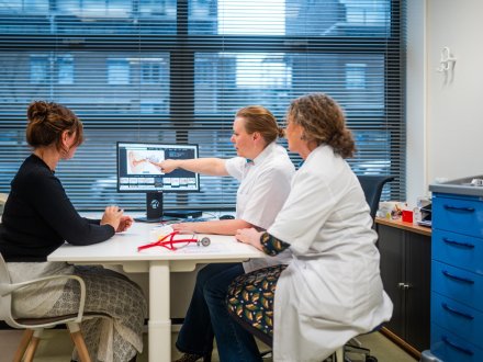 Studenten van de master Advanced Nursing Practice bekijken een afbeelding op een pc van de binnenkant van het gehoor.