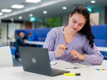 Een studerende studente met een laptop 