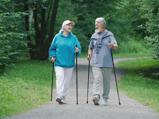 twee personen wandelend met nordic walking stokken