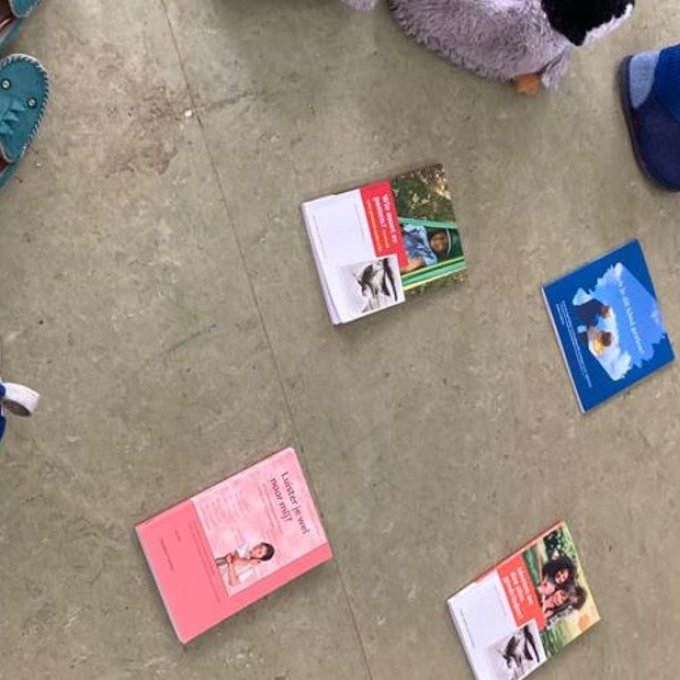 Een foto van verschillende boeken en schoenen op de grond