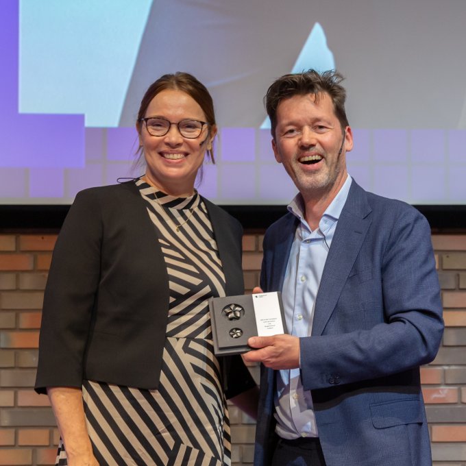 Vrouw en man met prijs in hand